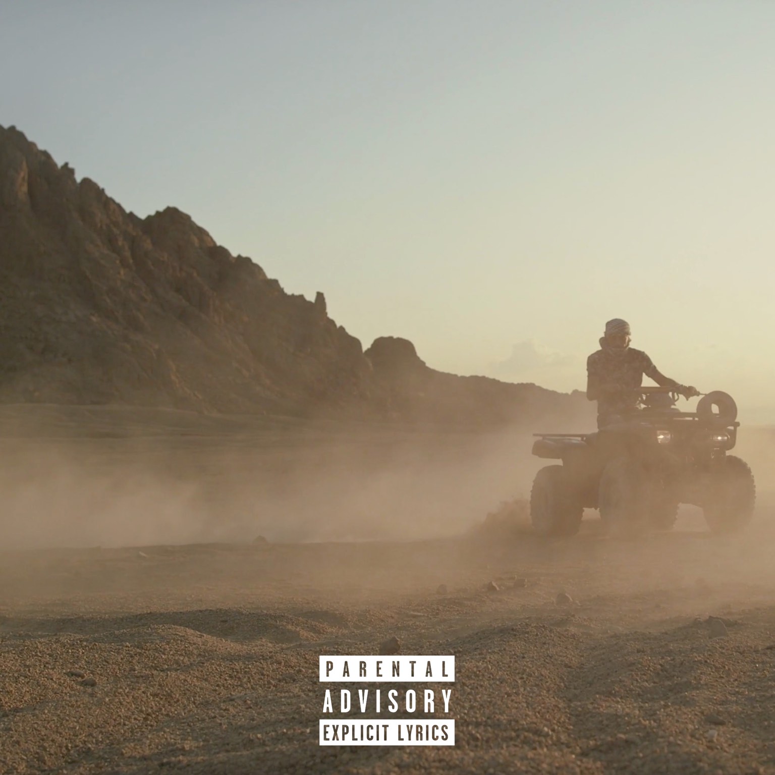 a man riding an atv in the desert